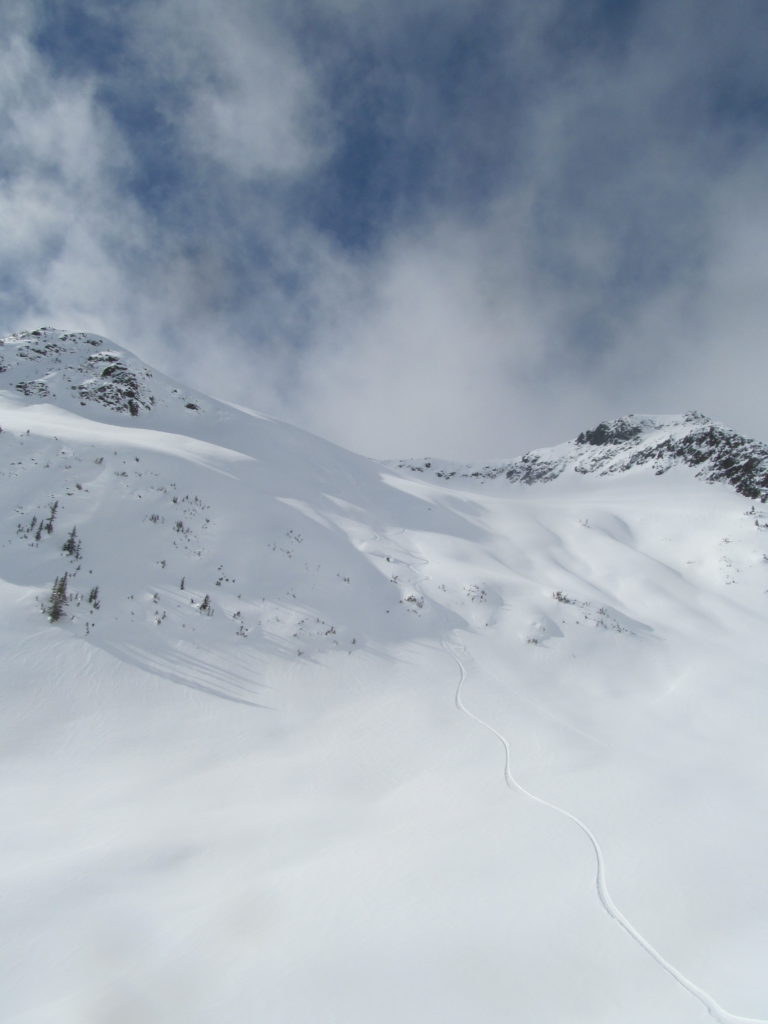 Snowboarding Powder off the backside of the Brian Waddington Hut