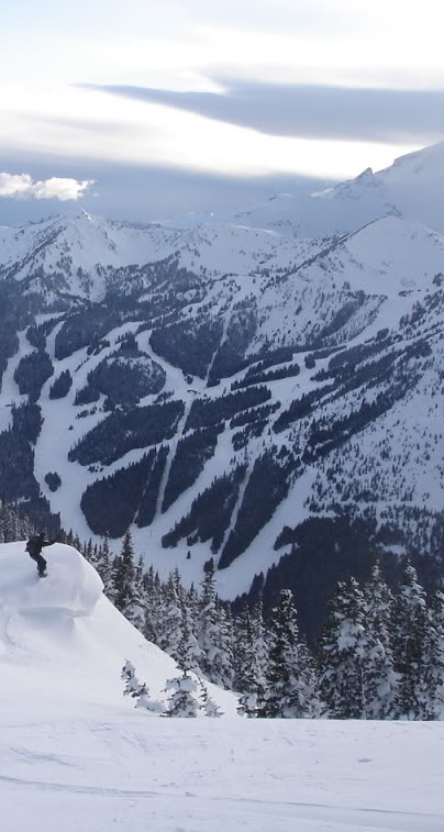 Snowboarding down East Peak with Crystal Mountain in the background