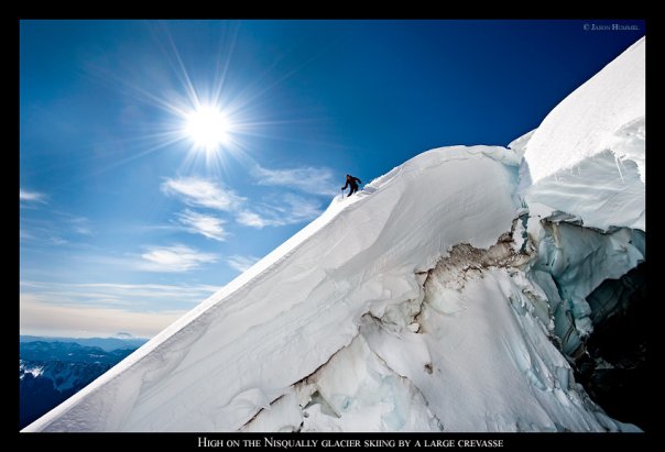 Josh skiing down on the edge of a crevasse