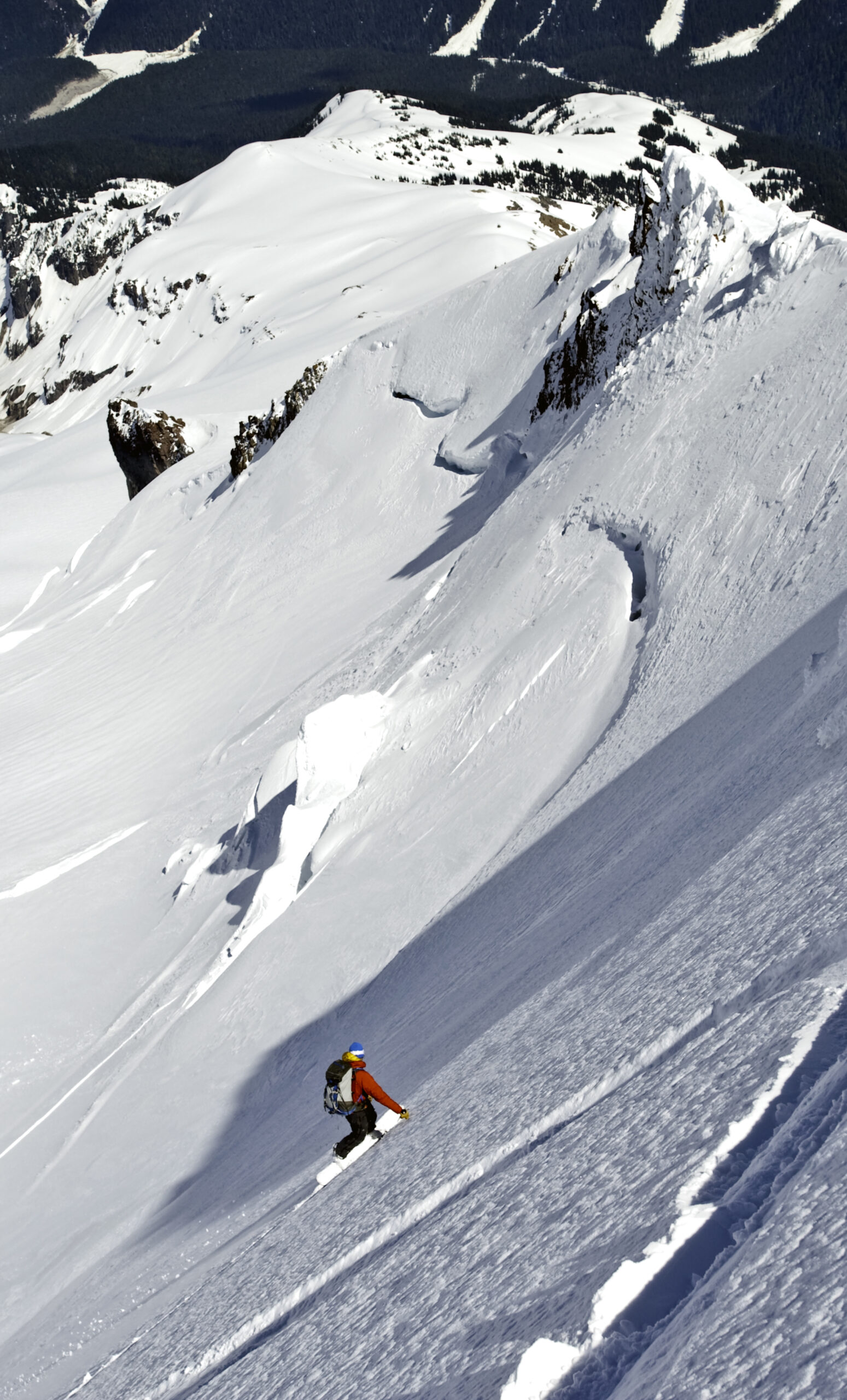 Snowboarding down the upper section of the Chocolate Glacier Headwall on Glacier Peak in Washington State
