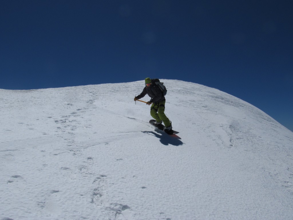 Snowboarding off the summit of Mount Rainier towards the Emmons Glacier in August