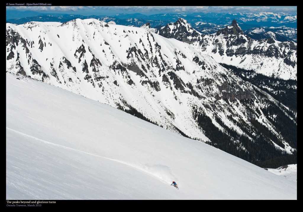 Snowboarding down with Old Desolate in the background in Mount Rainier National Park during the Osceola Traverse
