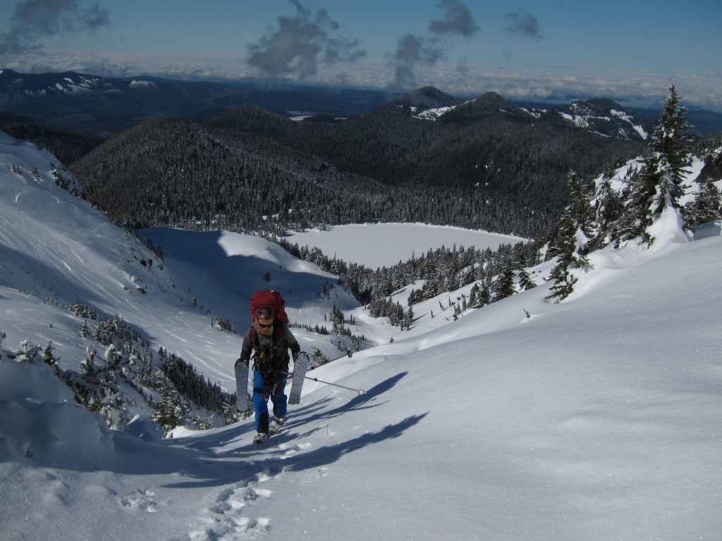 Jason Hummel making his was up Knapsack Pass with Mowich Lake in the background