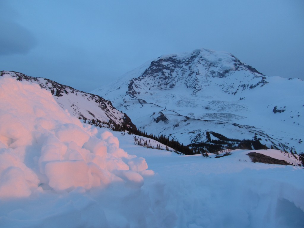 Alpenglow slowly creeping up Rainier with my debris pile on fire