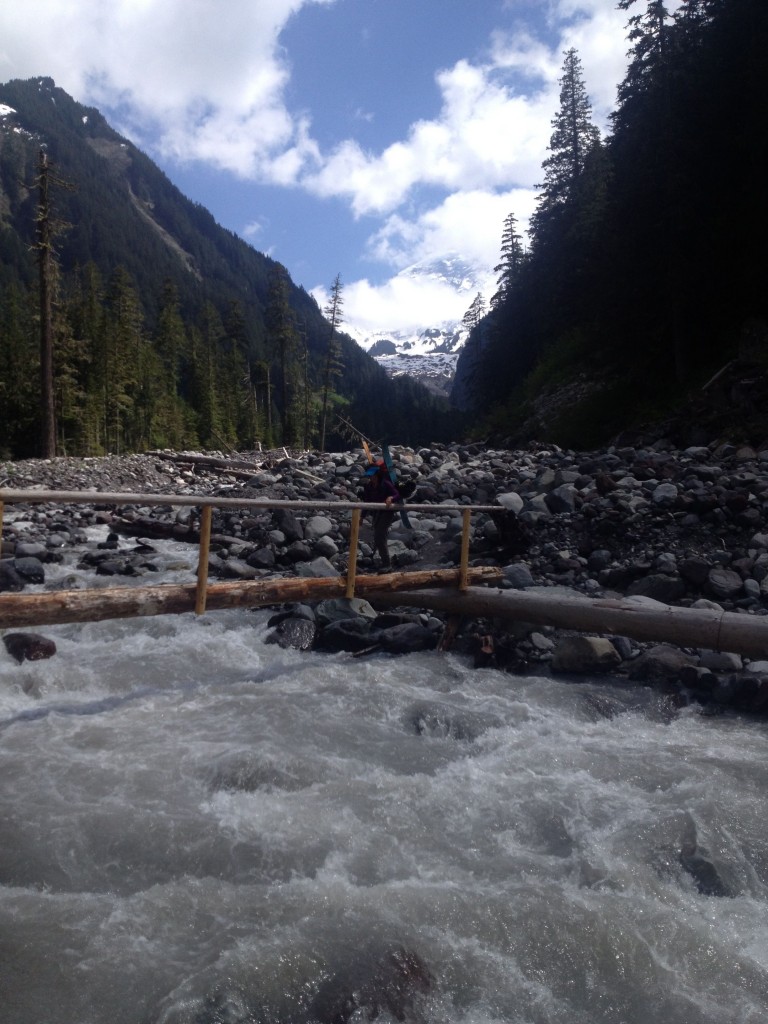 Heading across the Carbon River while ski touring along the Wonderland Trail