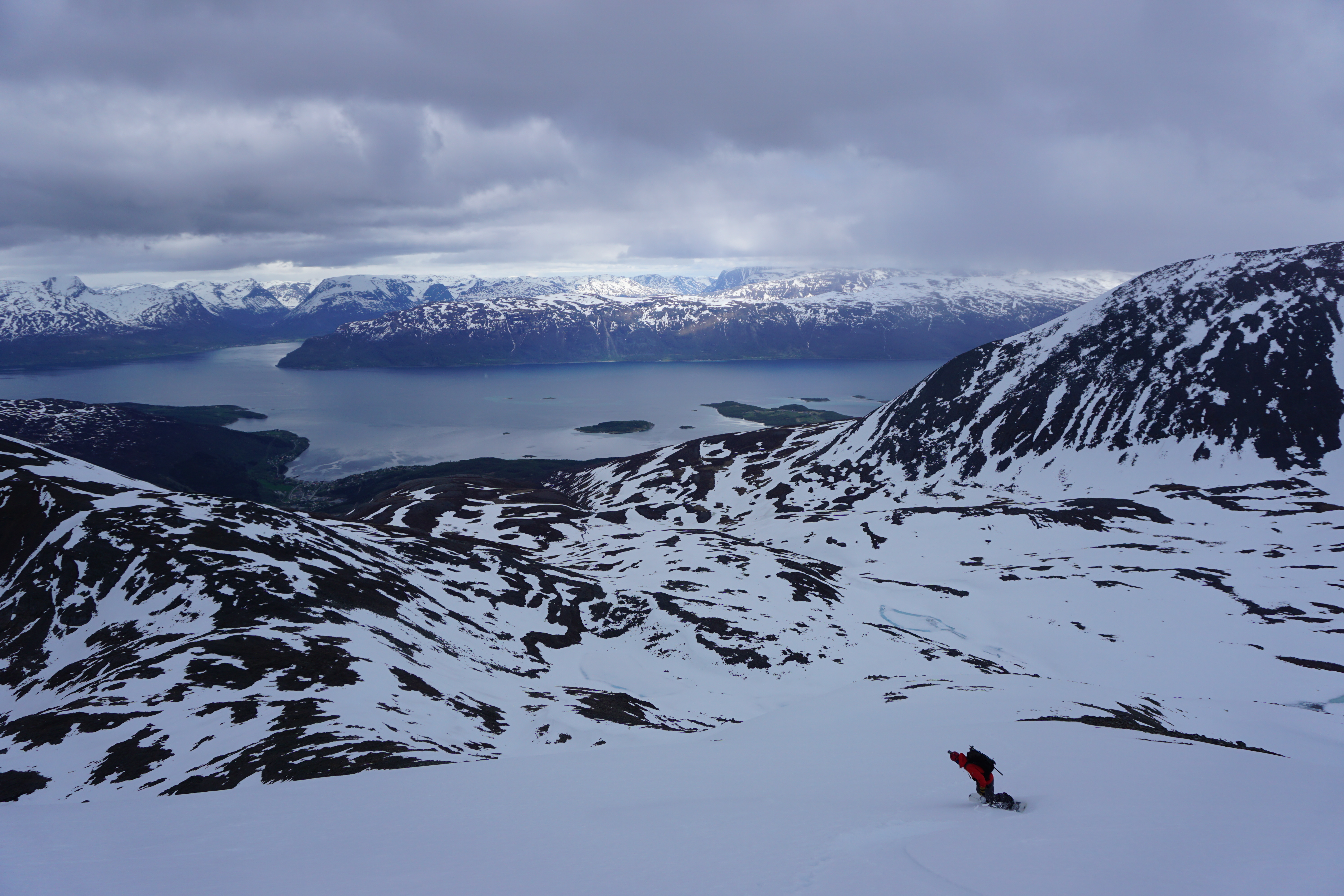 Snowboarding off the summit of Rornestinden