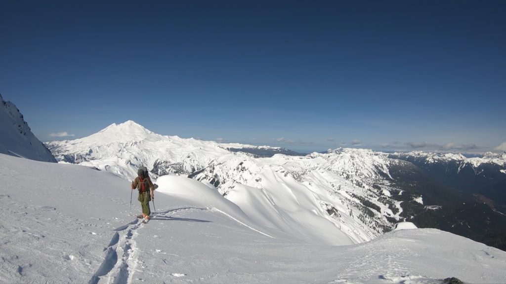 Climbing up the White Salmon Glacier with Mount Baker in the background