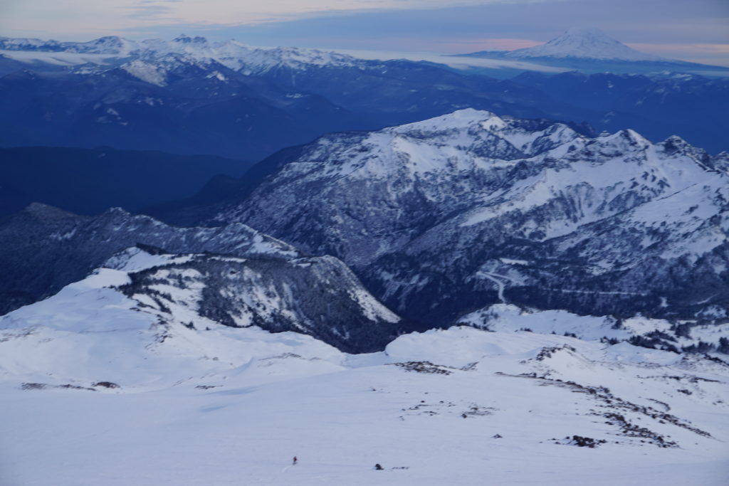 Amar being swallowed by the scenery in Mount Rainier National Park while skiing the Paradise Glacier