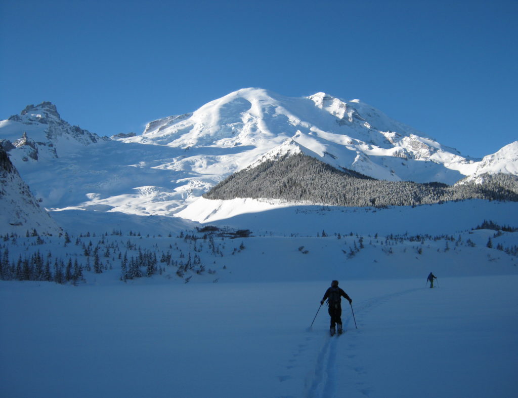 Breaking trail over to and up the Emmons glacier before snowboarding the middle Peaks North face