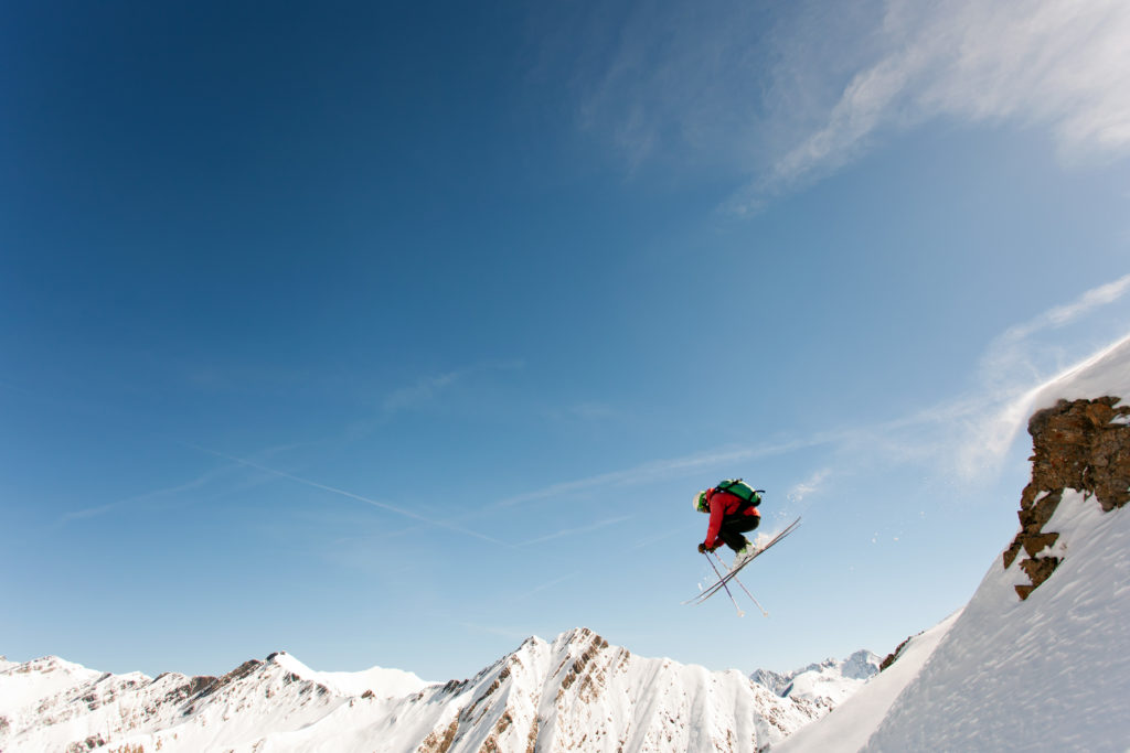 Marcus skiing off of a rock