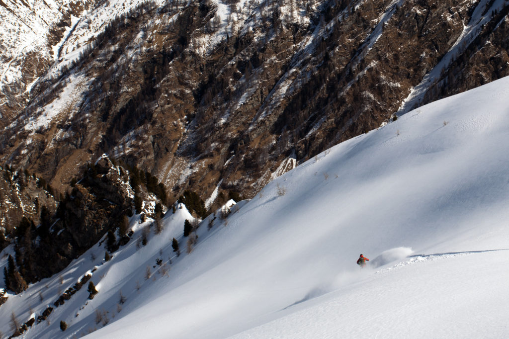 Enjoying snowboarding some great powder snow on Schmirntal while ski touring in Austria