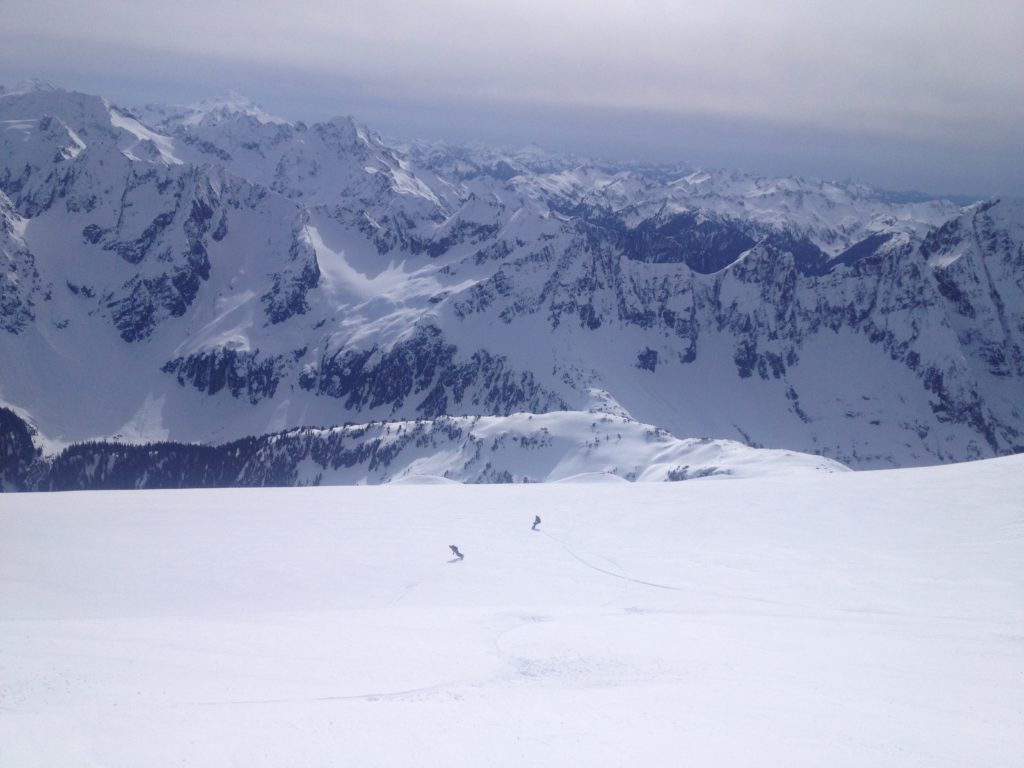 Snowboarding down the mid slopes of Sahale Mountain