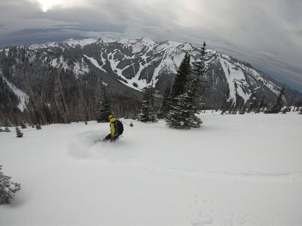 Snowboarding down the upper slopes of East Peak