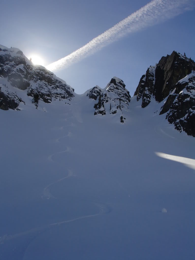 Looking back up at my snowboard tracks in perfect powder in the Sourdough Gap Chutes in the Crystal Mountain ski resort backcountry