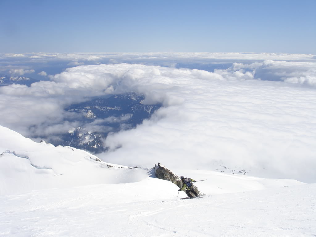 Taking ski turns off the summit of Mount Baker