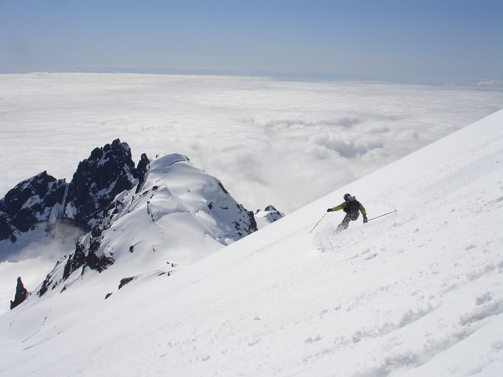 Skiing on the Roman Headwall towards the Easton Glacier from the summit of Mount Baker