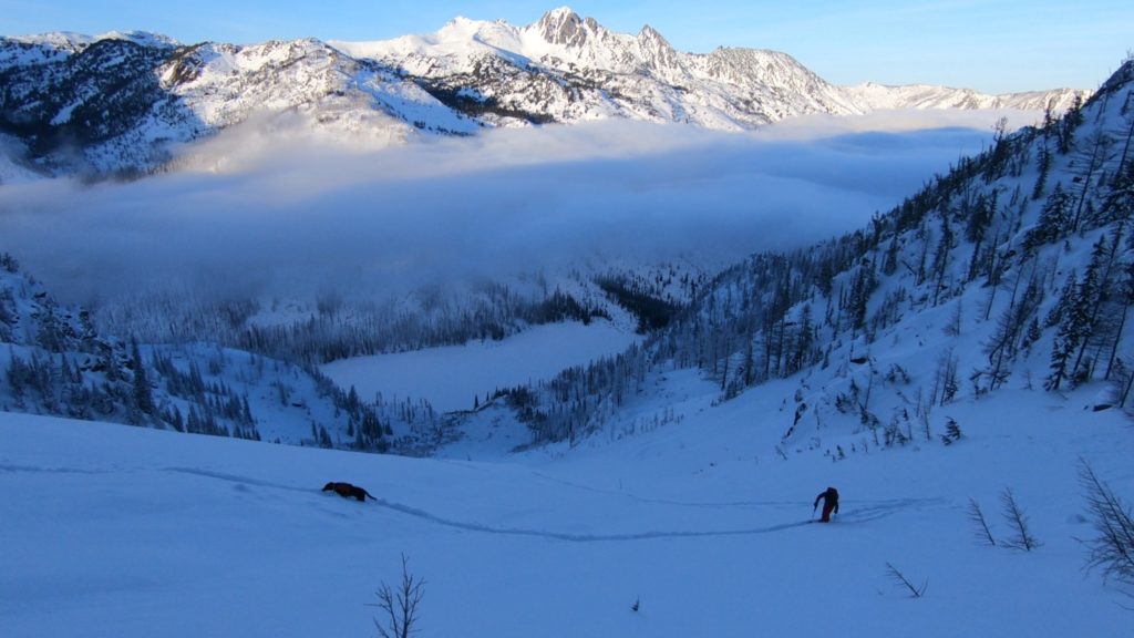 Ski touring above Eightmile Lake as the clouds start to move in