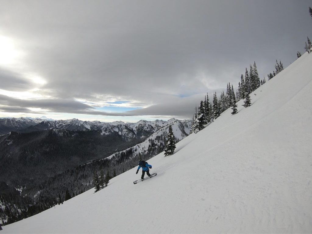 Snowboarding off the south face of Crown Point in the Crystal Mountain ski resort backcountry