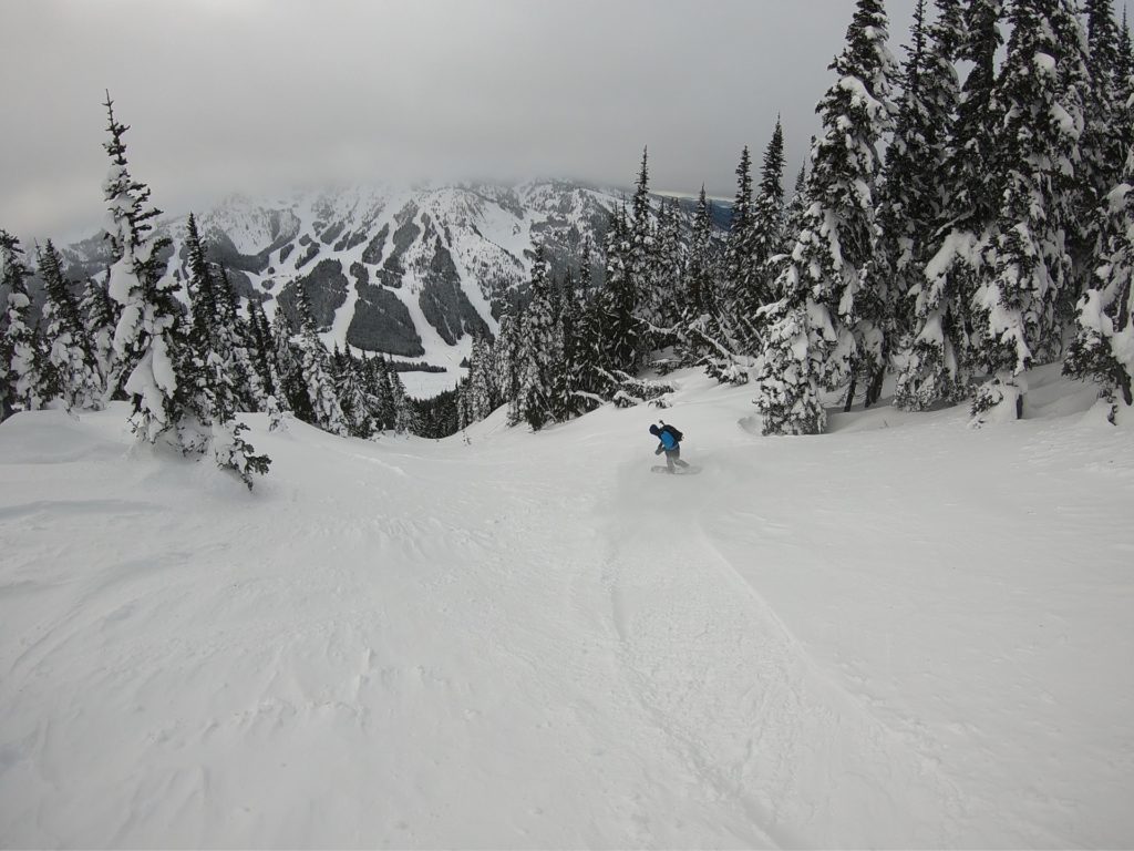 Snowboarding in the backcountry of Crystal Mountain ski resort after riding Crown Point