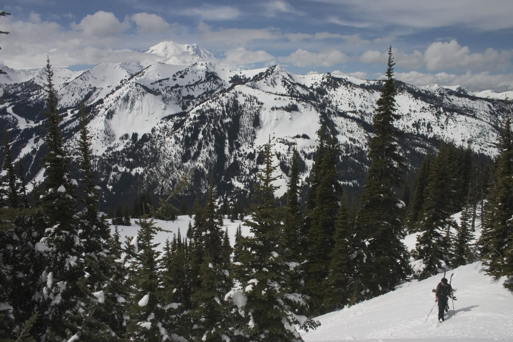 Boot packing up East Peak with Crystal Mountain in the background