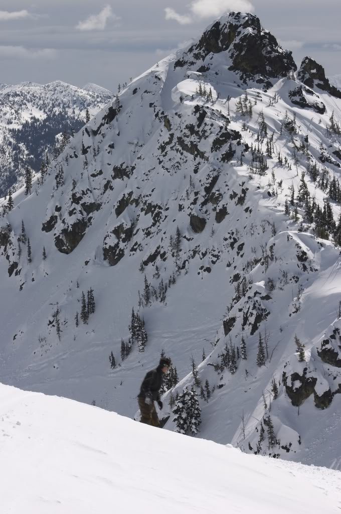 Snowboarding with 3 way Peak in the Background