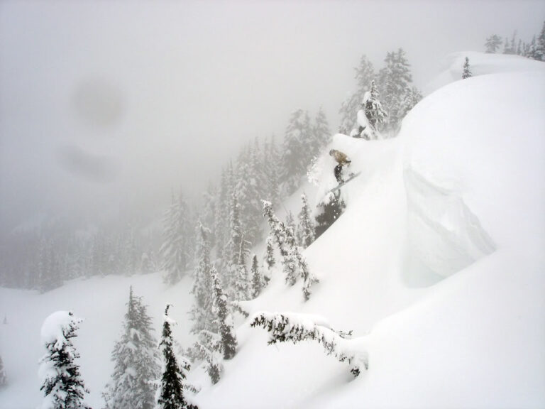 Dropping off a massive cornice into the Dog Leg bowl in Crystal Mountain Backcountry