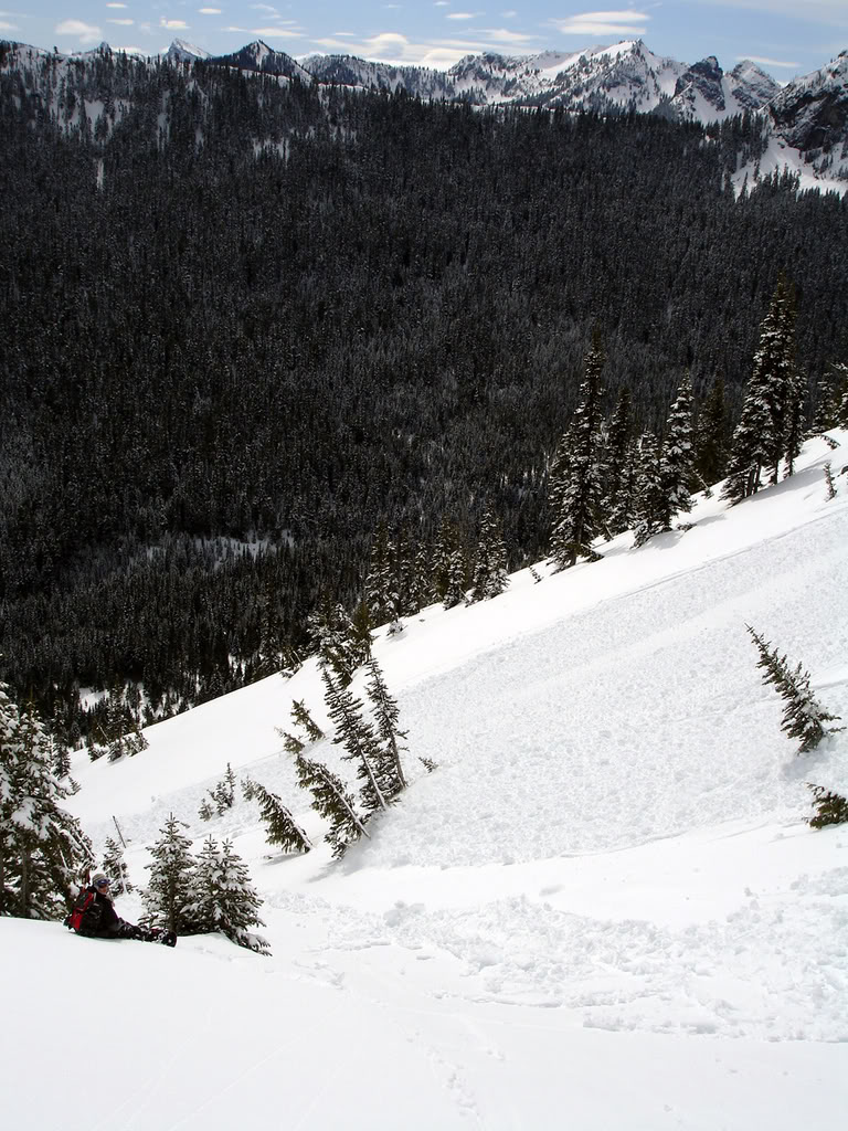 Kyle taking a break to look at the avi debris in the Crystal Mountain Backcountry