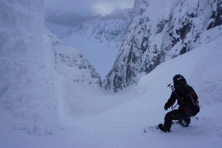 Preparing to snowboard into the Otkol Cirque in the Khibiny Mountains of Russia