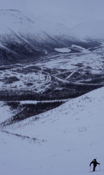 Ski touring up Mount Aikuaivenchorr in the Khibiny Mountains as the weather starts to change