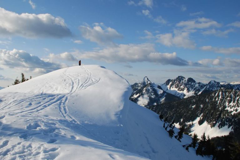 Skinning off the summit of Granite Peak with Kaleetan to the left and Chair peak to the right