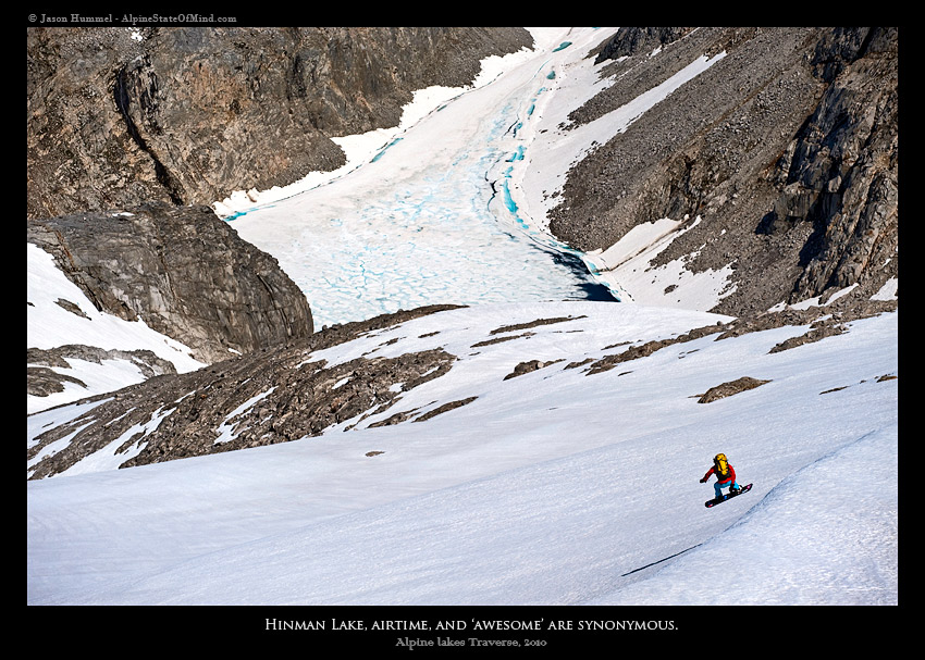 Snowboarding onto the Hinman Glacier with Hinman Lake in the background during the Alpine Lakes Ski Traverse in Alpine Lakes Wilderness