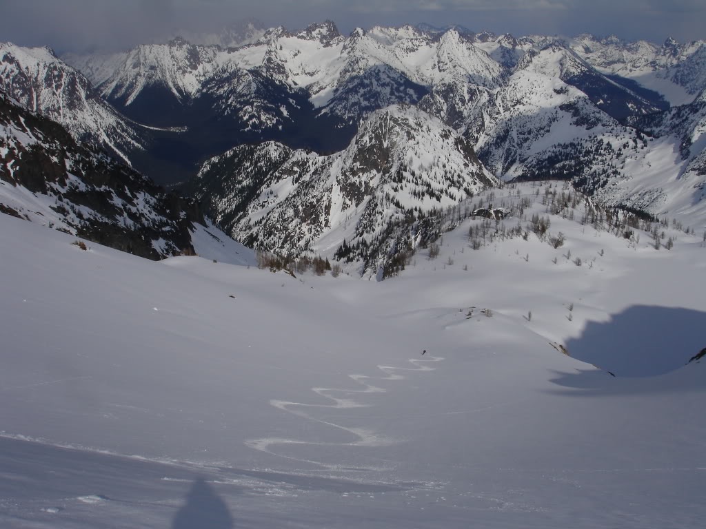 Smooth ski turns down the Col of Black Peak towards Highway 20