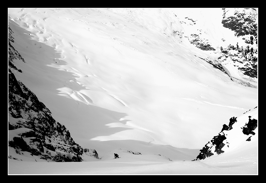 Snowboarding down the North Face of Buckner Mountain with the Boston Glacier in the distance