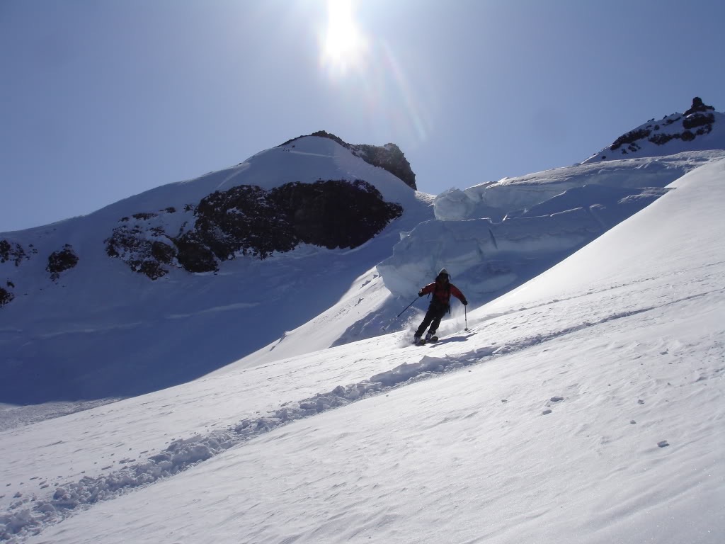 Amar skiing with a serac  in the background on the Cowlitz Glacier