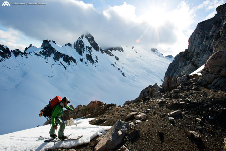 touring to Gunsight Notch with Dome Peak in the distance near North Cascades National Park on the Extended Ptarmagin Traverse