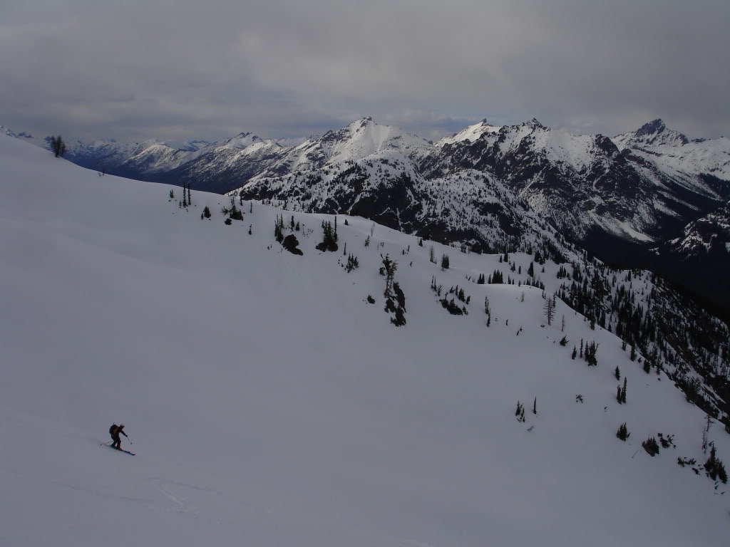 Skiing down to Rainy Lake on Frisco Mountain with the North Cascades in the background