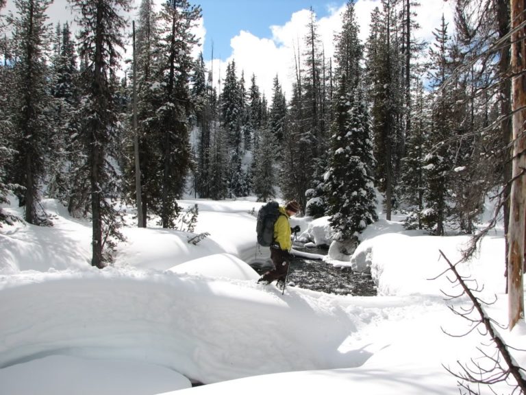 Crossing a snow bridge heading to Mount Bailey