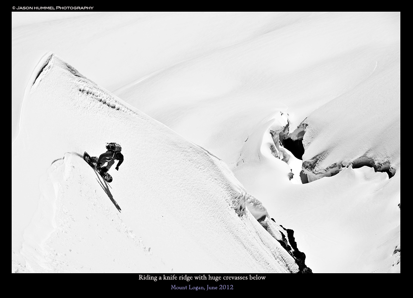 Snowboarding a knife ridge off the summit of Mount Logan with the Douglas Glacier in the background