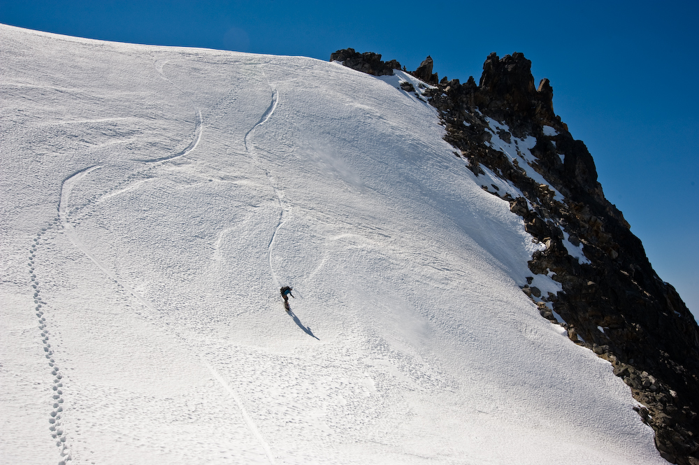 Snowboarding off the summit of Mount Challenger