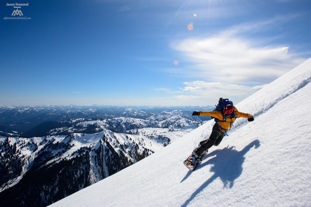 Snowboarding off the summit of Indian Head Peak