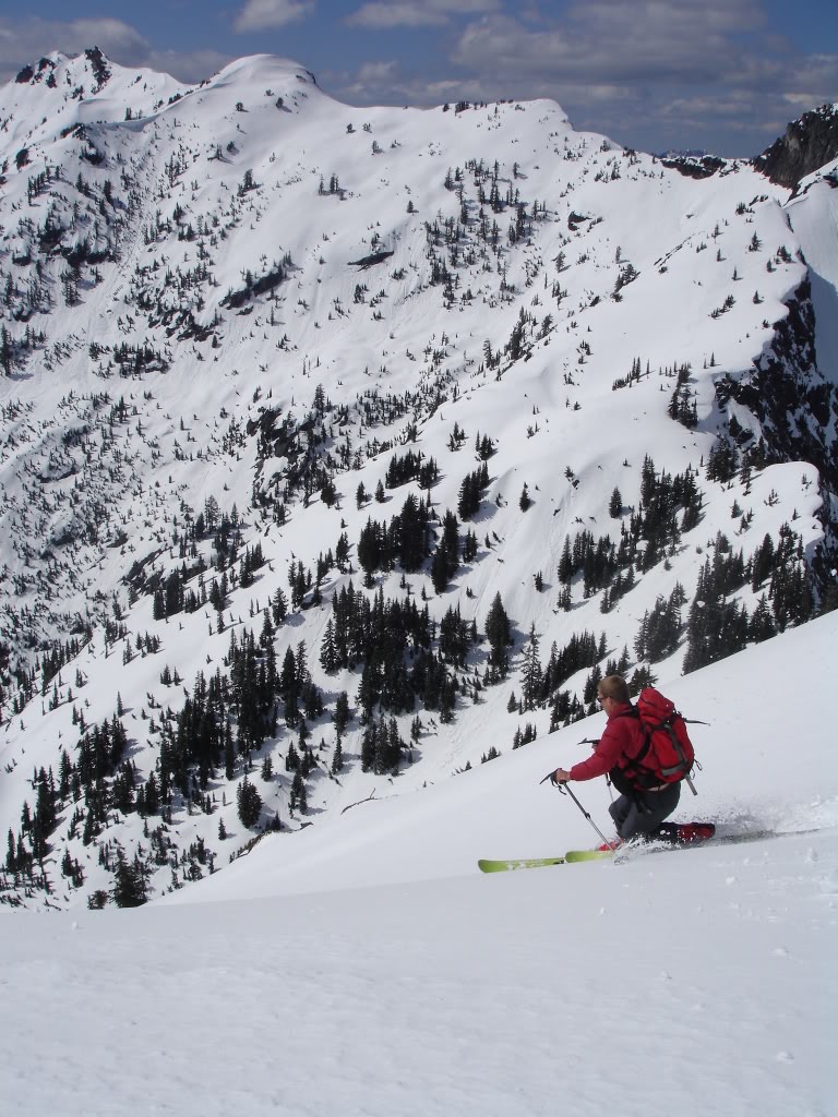 Jason skiing down Red Peak with Lundin Peak in the background