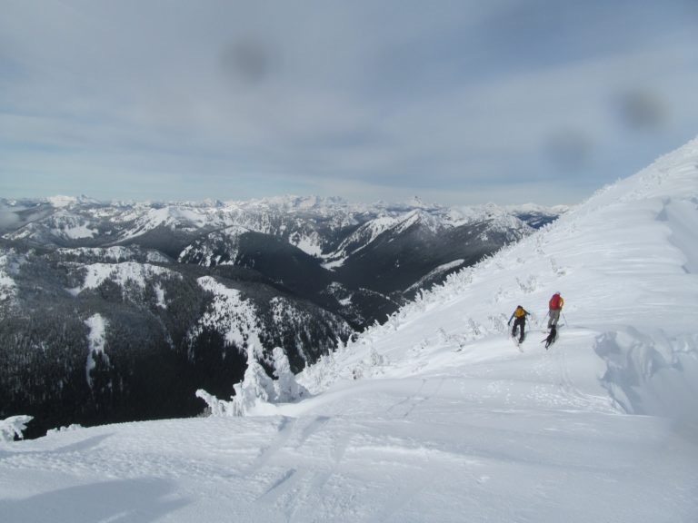 Ski touring up the summit ridge of Rock Mountain