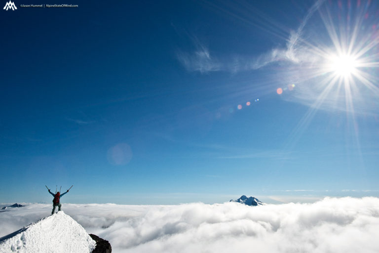 The summit of Fortress Mountain with Glacier Peak in the distance on the Suiattle Traverse