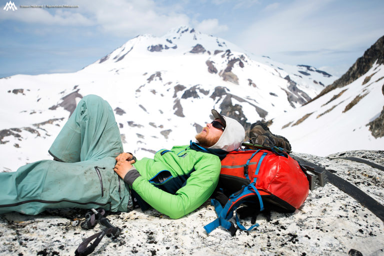 Resting near the summit of Glacier Peak and the Cool Glacier Route during the Suiattle Traverse