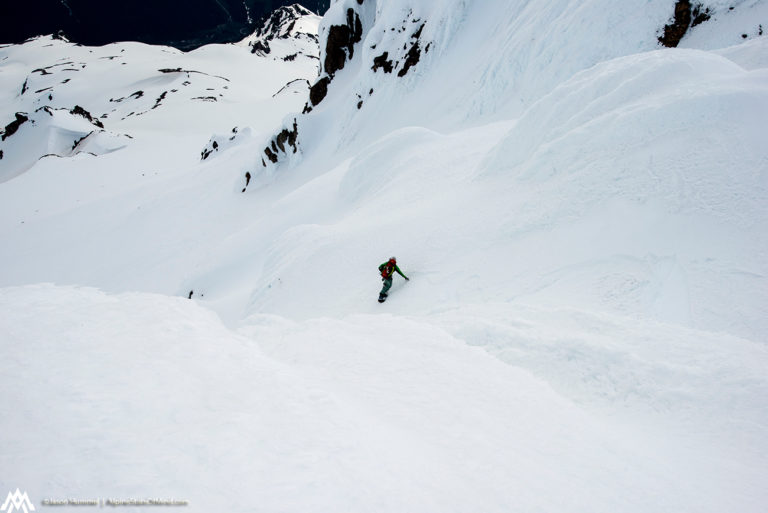 Snowboarding onto the Sitkum Glacier off the summit of Glacier Peak on the Suiattle Traverse