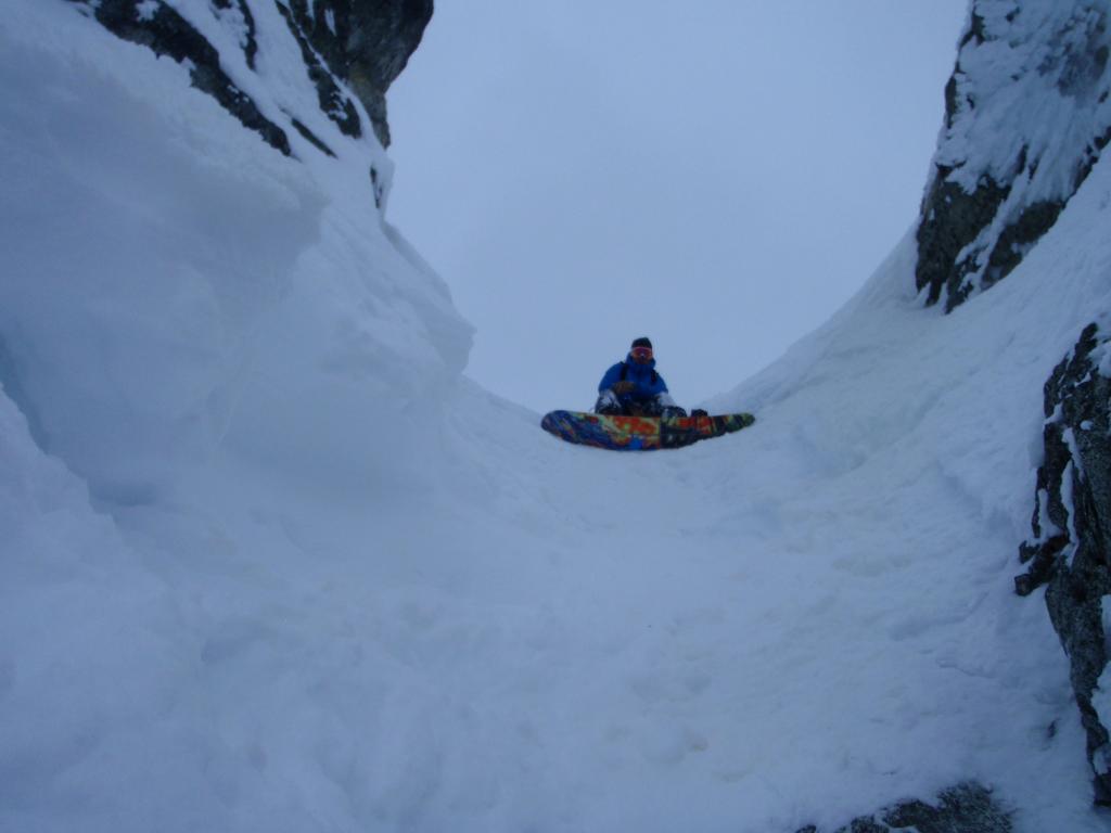 Preparing to snowboard down the Black Hole Couloir on Bandit Peak