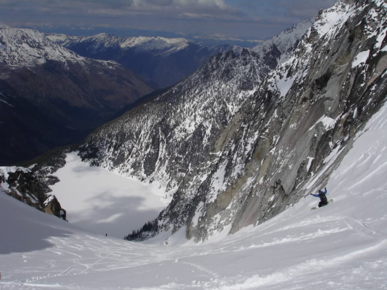 Jeff dropping in with Colchuck lake in the distance from Dragontail Peak