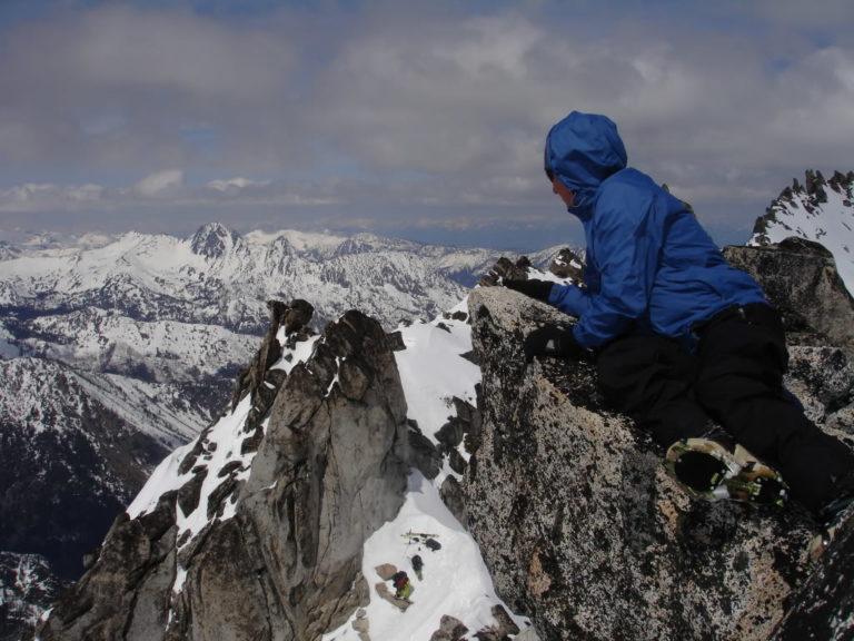 Jeff sitting on the Summit proper with Cashmere in the background from Dragontail Peak