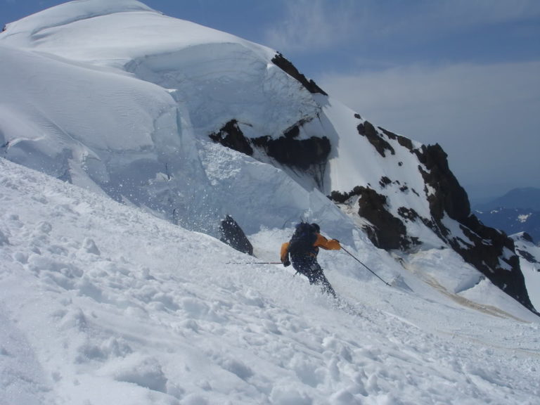 Dan skiing with Colfax peak in the background on the Coleman Deming Route of Mount Baker