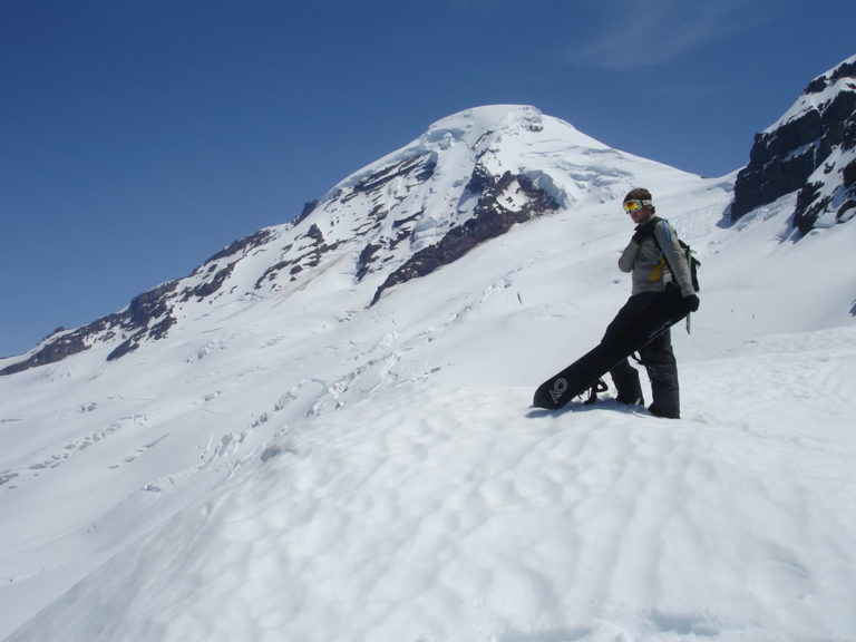 Getting our gear situated on Heliotrope Ridge for the decent with the Coleman Deming Route in the distance on Mount Baker